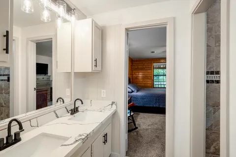 a en suite bathroom with a sink and a mirror