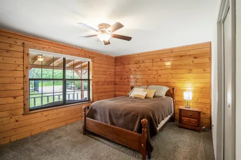 a bedroom with a bed and a window