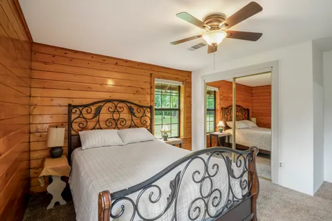 a bedroom with a bed and a window