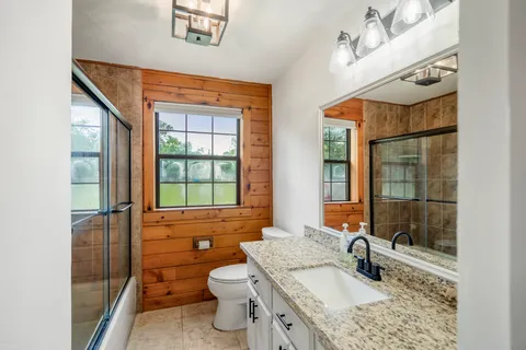 a bathroom with a sink toilet and shower