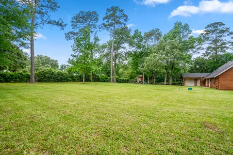 a view of a house with a backyard
