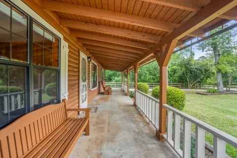 a view of a porch with wooden floor and roof