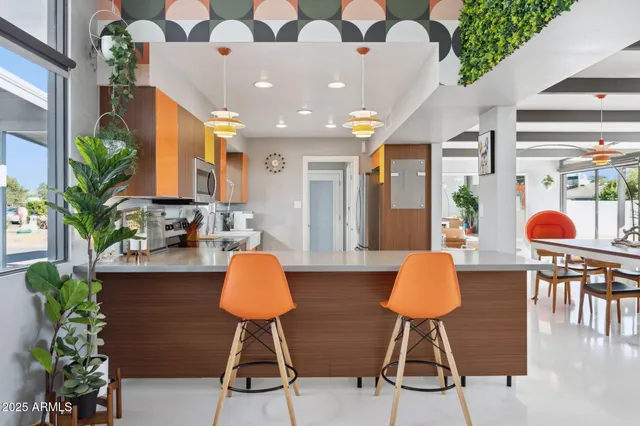 a kitchen with stainless steel appliances granite countertop a sink a stove top oven a counter space and cabinets