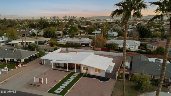 a living room with fireplace and a chandelier