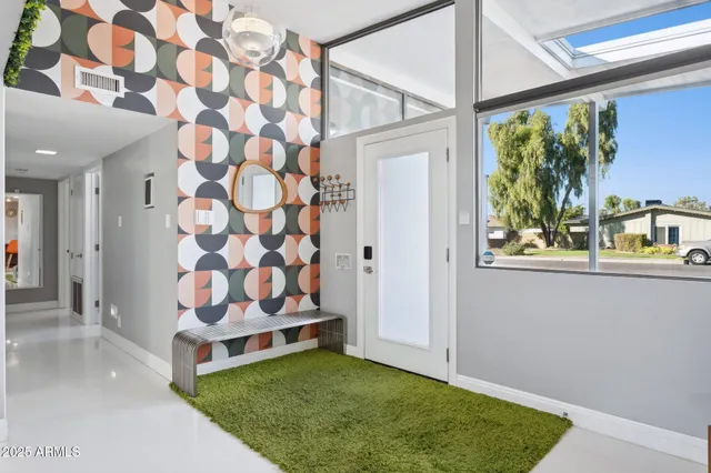 a bed sitting in a bedroom next to a window