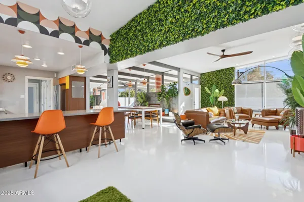 a living room with chairs and a table