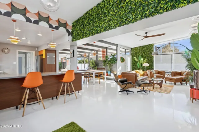 a living room with chairs and a table