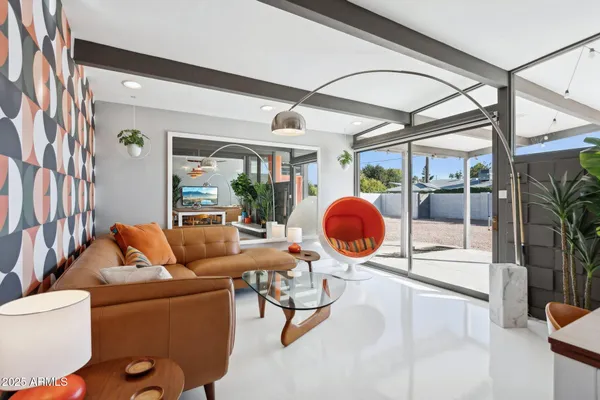 a living room with furniture a rug and a large window