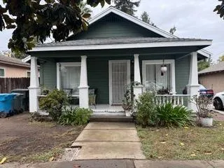 a view of a house with potted plants