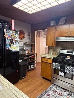 a kitchen with stainless steel appliances kitchen island granite countertop a sink and cabinets