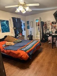 a bedroom with a bed and wooden floor