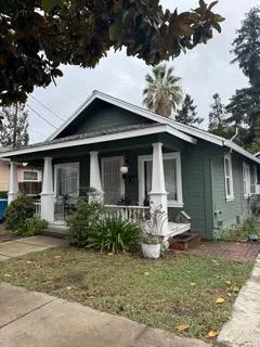 a view of a house with a yard patio and a garden