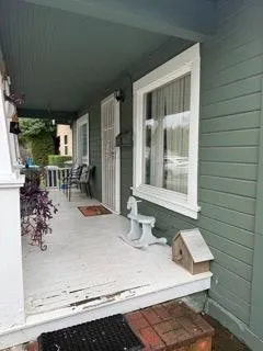 a building outdoor space with patio furniture and potted plants