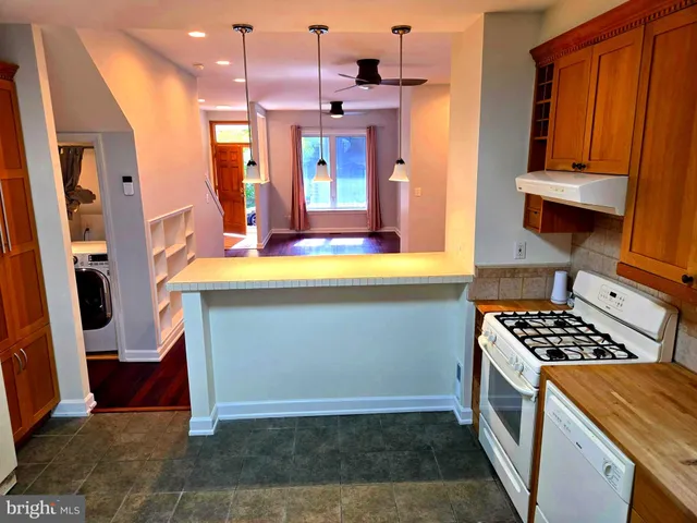 a kitchen with stainless steel appliances granite countertop a stove and a refrigerator