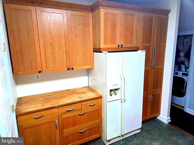 a view of a storage and utility room with washer and dryer