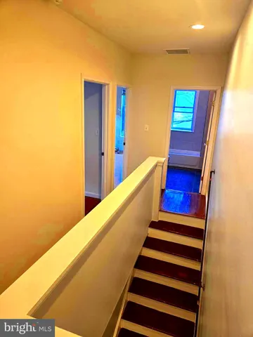 a view of a room with wooden floor and stairs