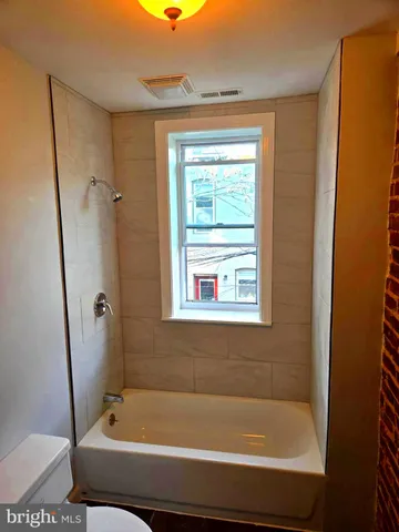 a bathroom with a bath tub and a shower