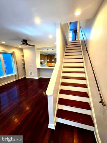 a view of entryway and hall with wooden floor