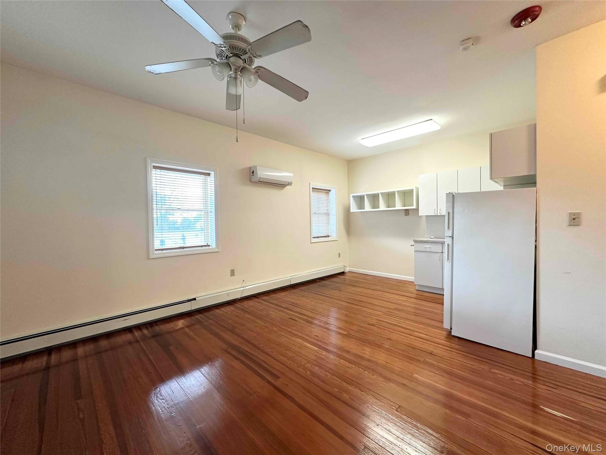 503 Hicksville Road, Unit 2F Massapequa, NY 11758 - Photo 1 of 1 a view of empty room with wooden floor and ceiling fan