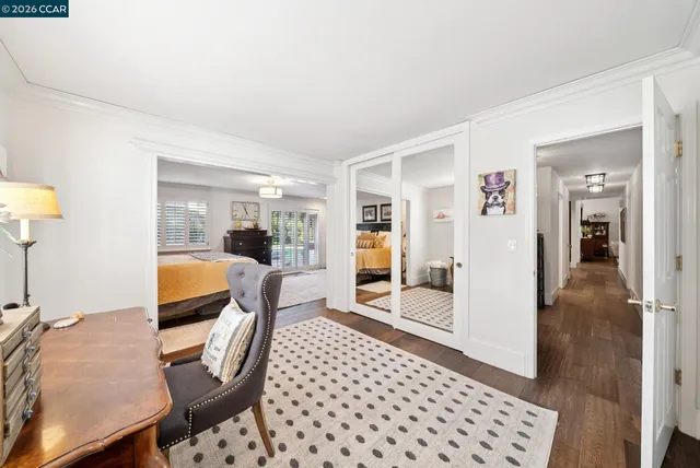 a bathroom with a granite countertop sink a toilet a mirror and shower
