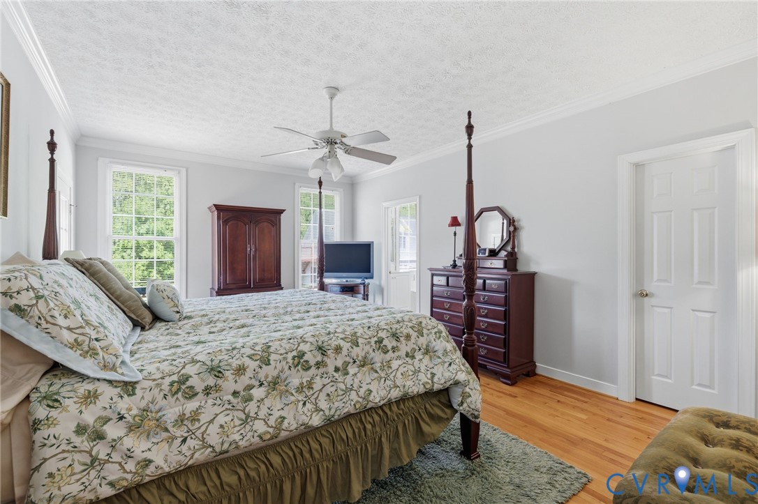 15441 Goshen Road Montpelier, VA 23192 - Photo 23 of 47 a bedroom with a bed and a chandelier