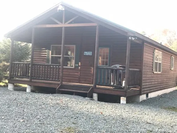a view of a house with a small deck