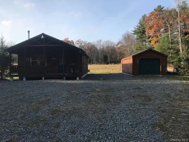 a front view of house with yard and trees