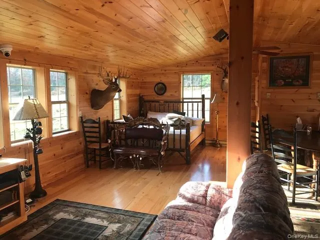a view of a livingroom with furniture wooden floor and windows