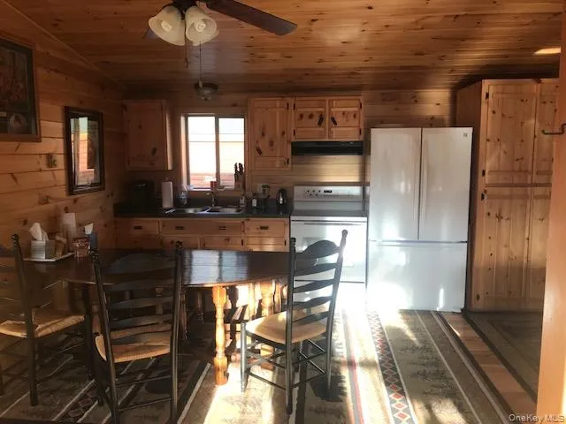 a kitchen with stainless steel appliances kitchen island granite countertop a refrigerator and a stove