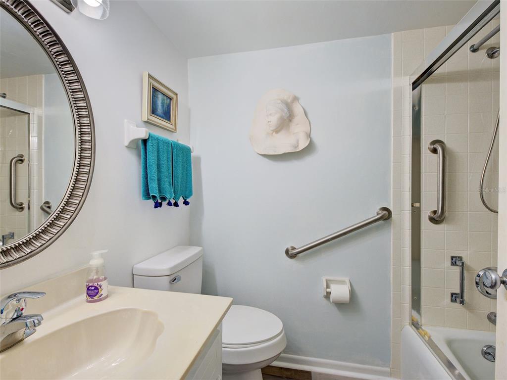 633 Alhambra Road, Unit 1006 Venice, FL 34285 - Photo 17 of 55 a bathroom with a sink mirror vanity and toilet