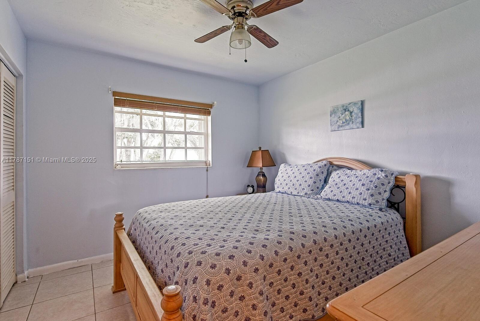 Kendall Miami, FL 33176 - Photo 12 of 26 a bedroom with a bed and window