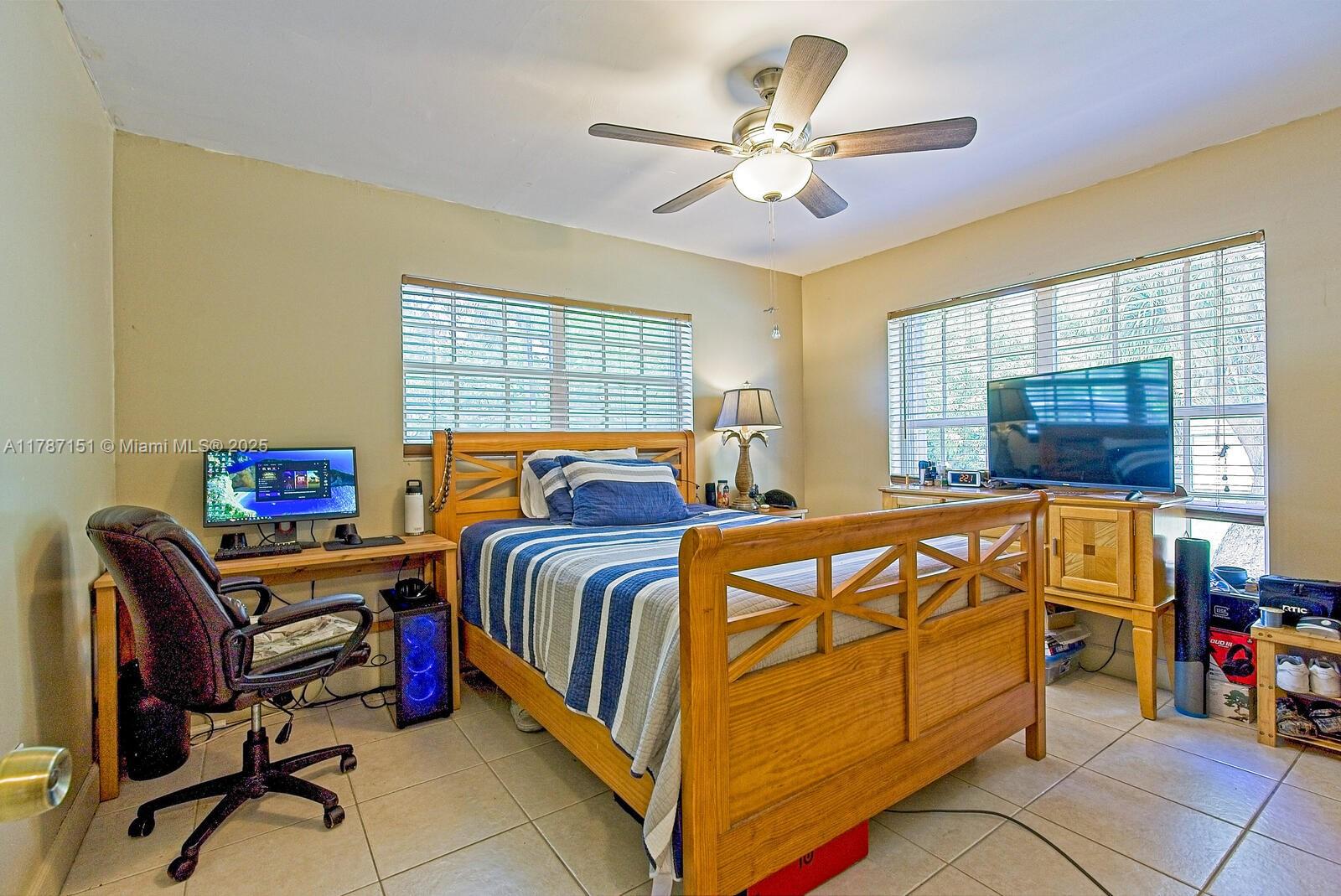 Kendall Miami, FL 33176 - Photo 19 of 26 a bedroom with a bed and a chandelier