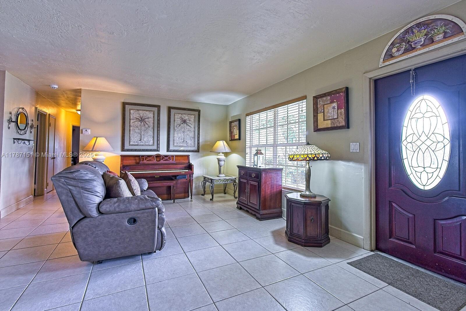 Kendall Miami, FL 33176 - Photo 2 of 26 a living room with furniture a window and a clock