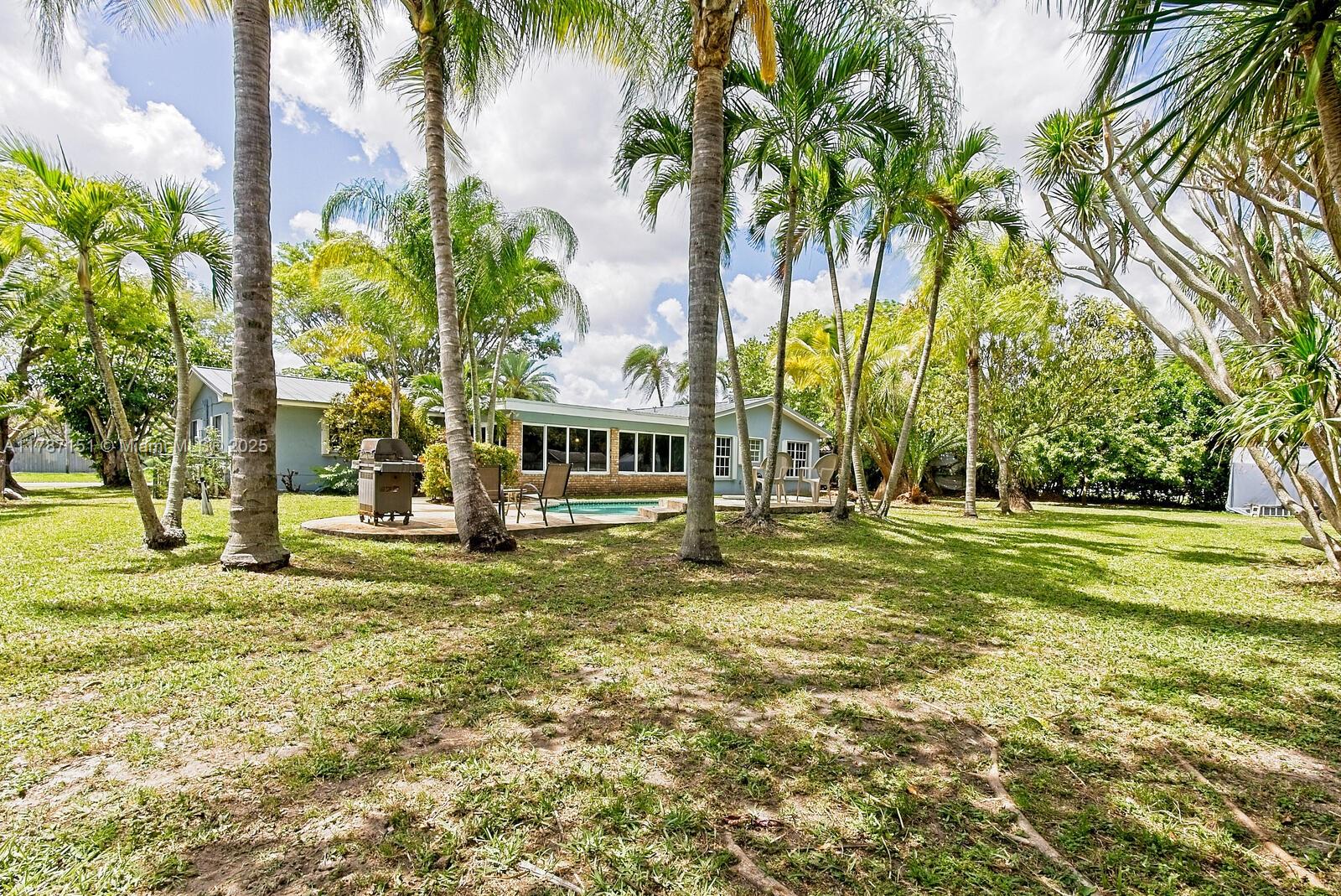 Kendall Miami, FL 33176 - Photo 22 of 26 a view of a house with a big yard and palm trees
