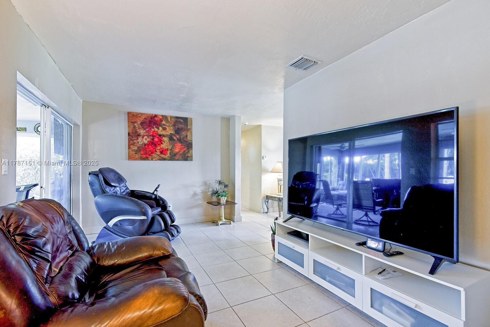 Kendall Miami, FL 33176 - Photo 6 of 26 a living room with furniture gym equipment and a flat screen tv
