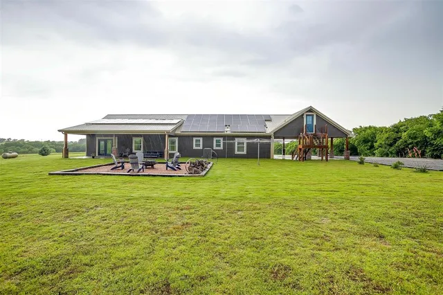 a front view of house with yard patio and green space