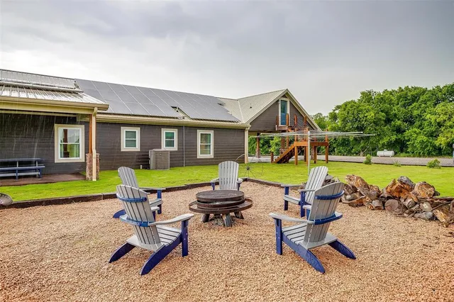 a building outdoor space with patio furniture and garden