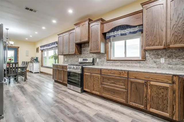 a kitchen with stainless steel appliances sink refrigerator and microwave