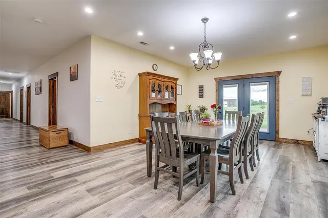 a view of a dining room with furniture wooden floor and chandelier