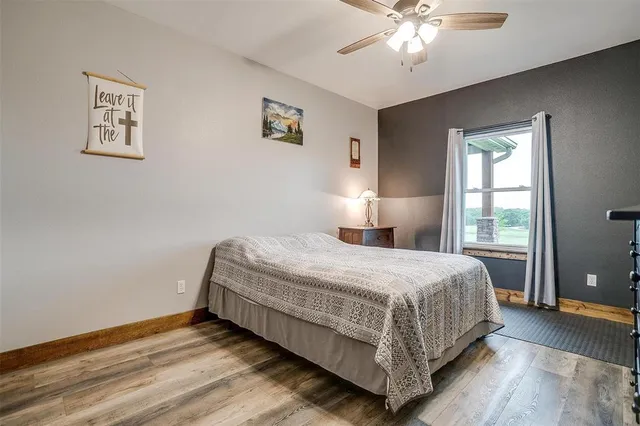 a spacious bedroom with a bed and a chandelier