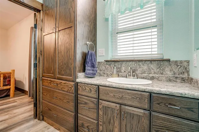 a view of kitchen with granite countertop cabinets and refrigerator