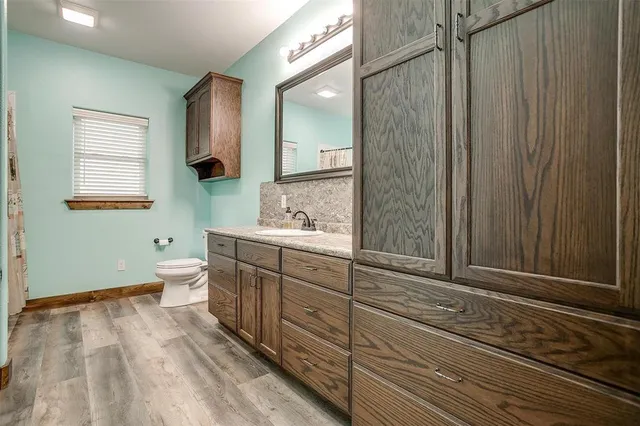 a bathroom with a toilet sink and mirror