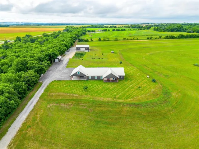 a view of a swimming pool with a garden and seating area