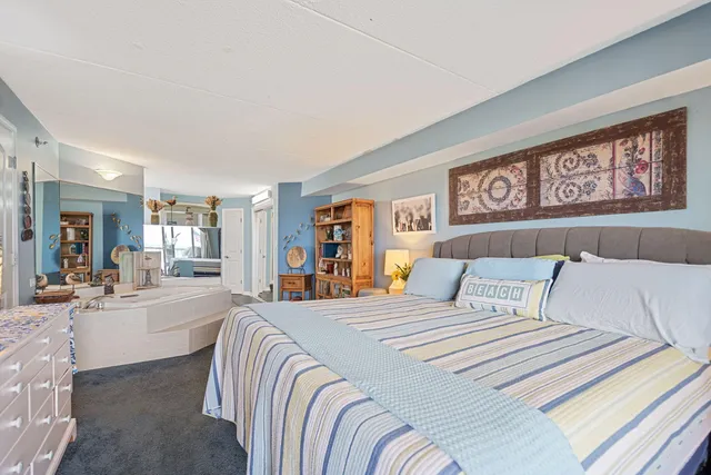 a bedroom with a large bed and a couch