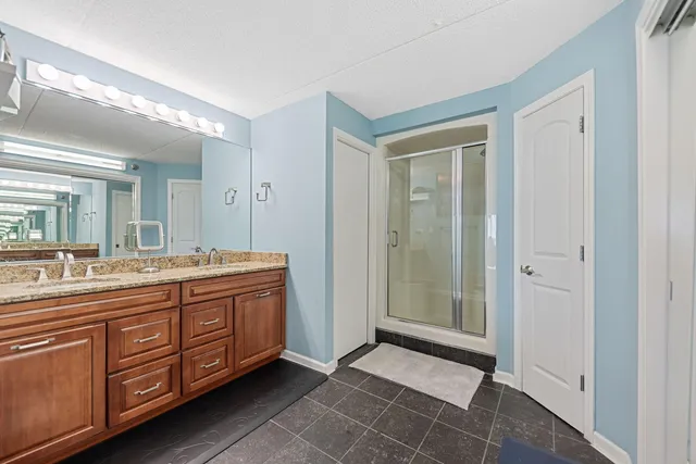 a spacious bathroom with a double vanity sink and a mirror