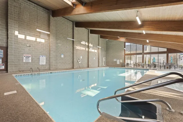 a view of a room with gym equipment and a large window