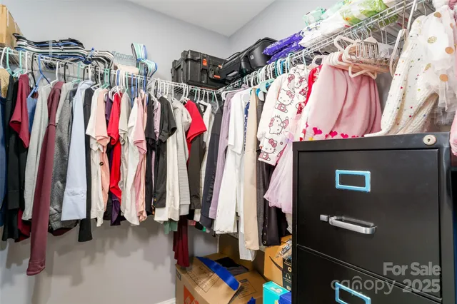 a view of a house with backyard and trees