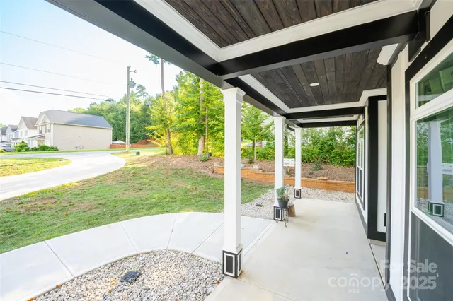 a view of a porch with chairs and backyard