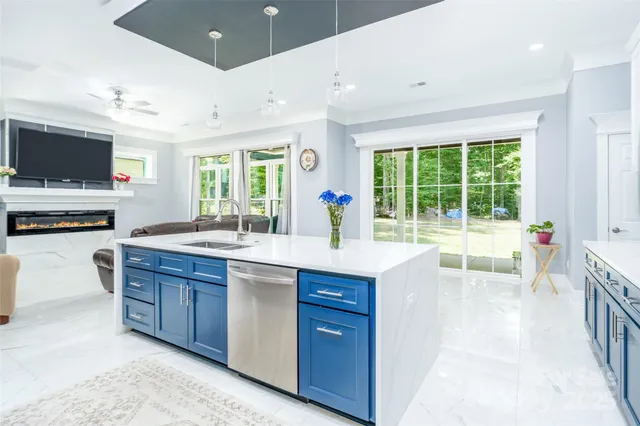 a large kitchen with kitchen island granite countertop a large window and a sink