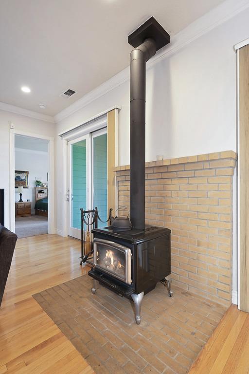 5901 Traverse Creek Road Garden Valley, CA 95633 - Photo 34 of 98 detailed view of ornamental molding, wood finished floors, a wood stove, and recessed lighting